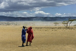 Discussion, une photographie fascinante capturant une conversation intense entre deux Massaïs sous le vent de Tanzanie